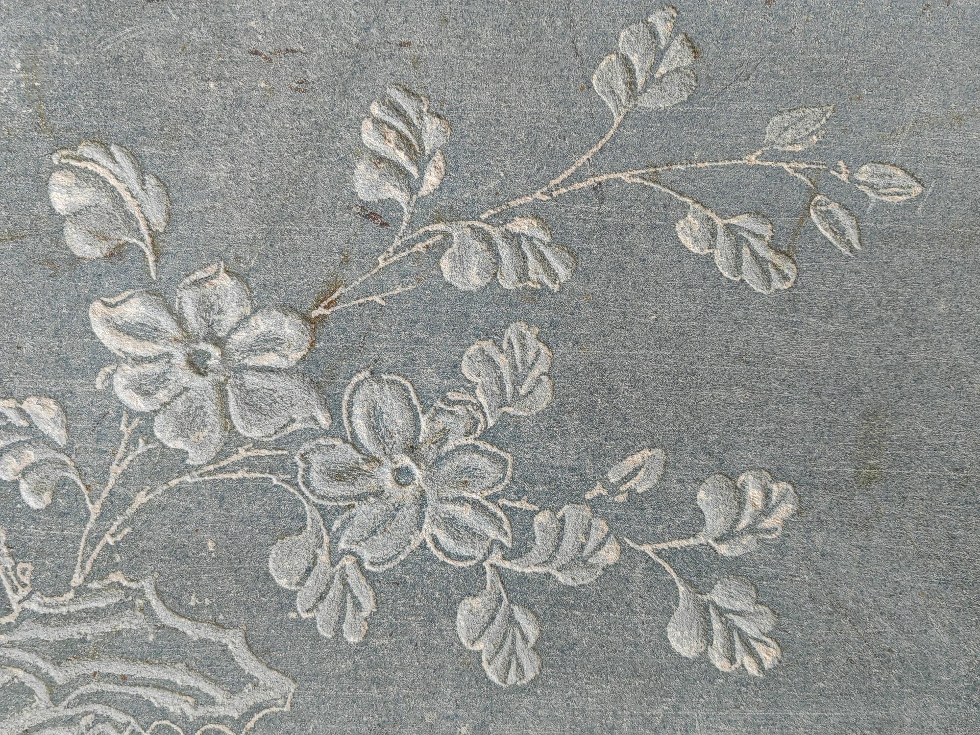 detailed satin-stitch floral motif on cotton